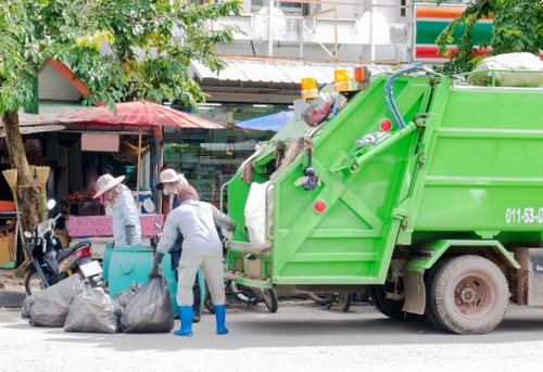 Man and van loading commercial waste outside a Thamesmead shopfront